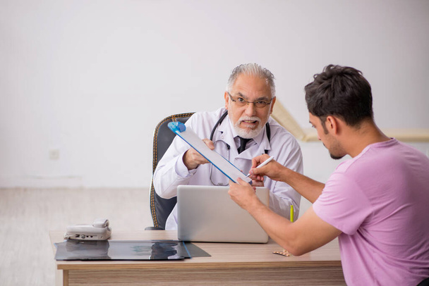 Young patient visiting old male doctor - Photo, Image