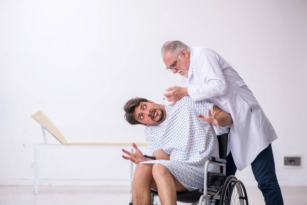 Öreg orvos pszichiáter vizsgálja a fiatal fogyatékos beteg - Fotó, kép