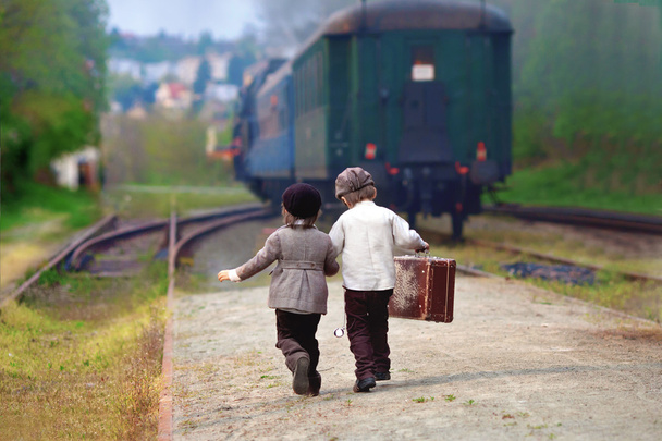 Two boys, dressed in vintage clothing and hat, with suitcase - Foto, Imagem