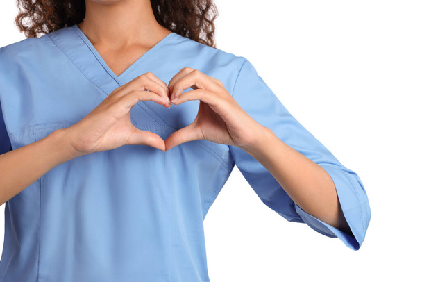 African-American doctor making heart with hands on white background, closeup - Фото, зображення