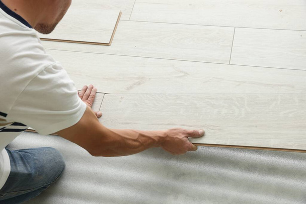Man installing new laminate flooring, closeup view - Φωτογραφία, εικόνα