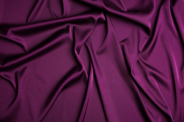 Crumpled purple silk fabric as background, top view - Foto, Bild