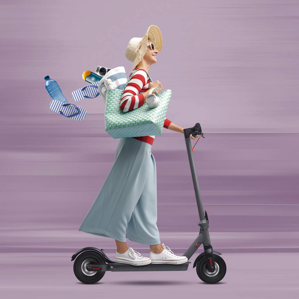 Happy fashionable woman riding a fast electric scooter and going to the beach, she is losing her accessories - Zdjęcie, obraz
