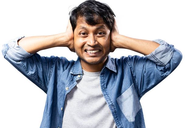 Facial expression of an Indian male to noise pollution covering both ears - Photo, Image