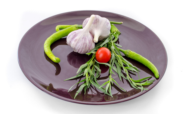 Tomatoes and garlic in purple plate on white background. - Photo, Image