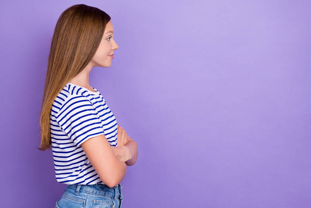 Photo of funny optimistic girl with straight hairdo striped t-shirt look empty space arms crossed isolated on purple color background. - Photo, Image