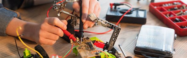 Cropped view of child making robotic model with millimeter at home, banner  - Photo, Image