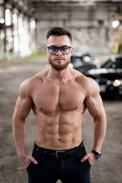 Young sporty muscular man with shirtless body. Handsome athletic lifestyle sexy guy. - Valokuva, kuva