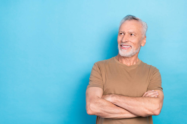 Photo of retired positive man wear trendy pastel clothes interested look empty space cool proposition isolated on blue color background. - Фото, зображення