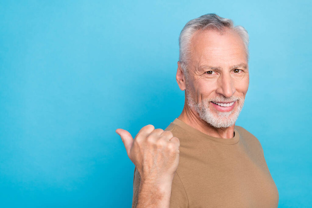 Close up photo of attractive positive man wear pastel trendy clothes arm direct present empty space isolated on blue color background. - Fotografie, Obrázek