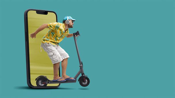 Cool man riding a fast electric scooter and coming out from a smartphone screen, blank copy space - Photo, Image