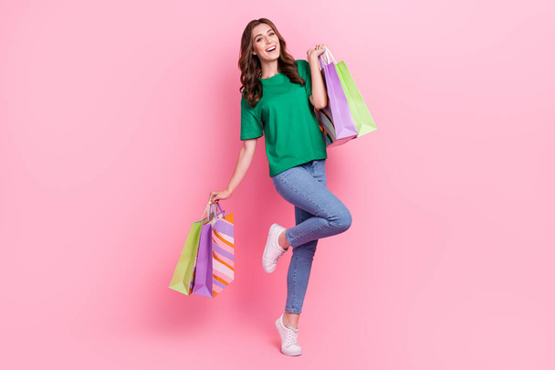 Full length photo of cheerful satisfied lady hand hold carry package wear trendy clothes new collection isolated on pink color background. - Fotografie, Obrázek