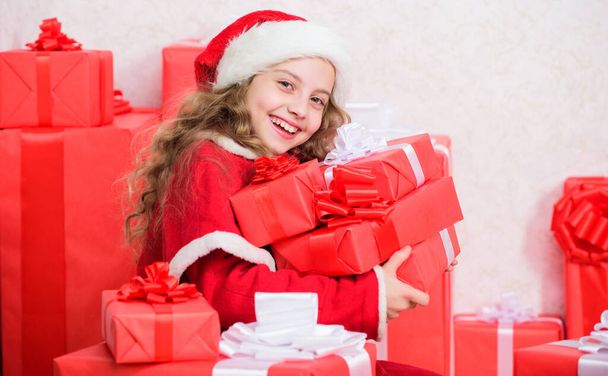 Kid helping santa. New year holiday tradition. Little santas helper concept. Kid excited about opening christmas present. Explore christmas gifts. Unpacking christmas gift. Girl celebrate christmas. - Foto, afbeelding