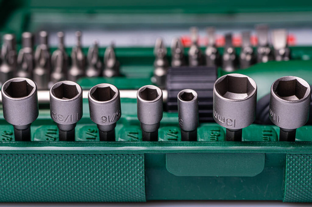 Interchangeable screwdriver set with different types of metal steel heads and bits, selective focus - Fotoğraf, Görsel