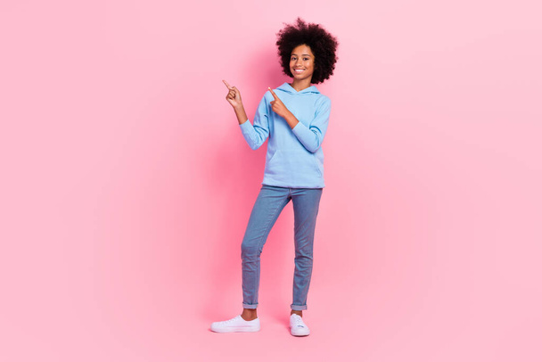 Full length photo of cheerful nice person indicate fingers empty space isolated on pink color background. - Zdjęcie, obraz