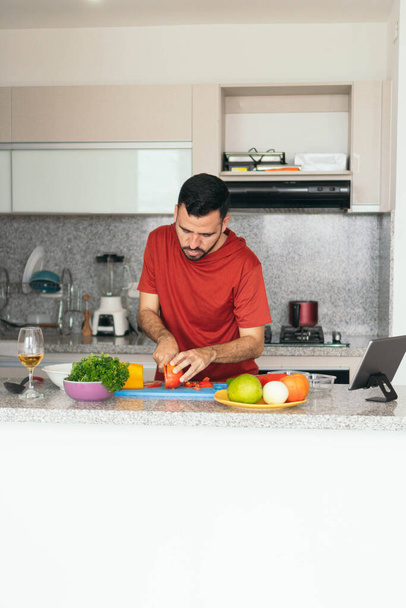 Hispanic Man Making A Salad At Home - Photo, image