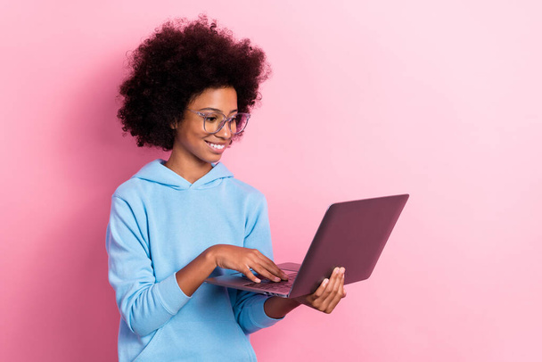 Photo portrait of cute pupil girl holding laptop eyeglasses doing homework wear trendy blue garment isolated on pink color background. - Φωτογραφία, εικόνα