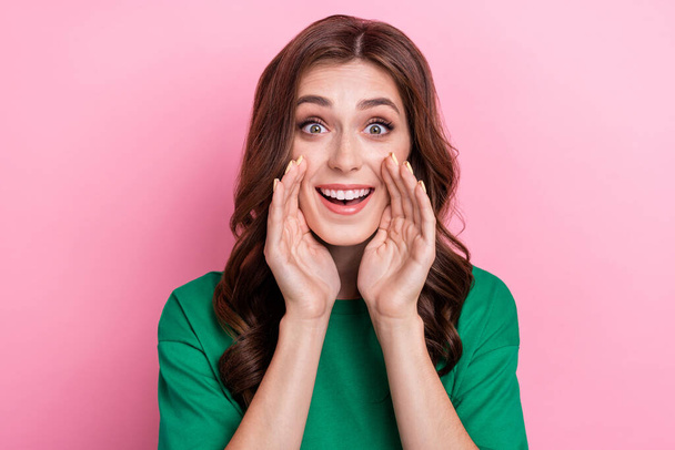 Photo of impressed optimistic funny girl with wavy hairdo dressed green t-shirt whispering secret isolated on pink color background. - Foto, Imagen