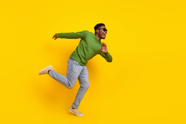 Full length body size view of attractive cheerful guy running fooling having fun isolated on bright yellow color background. - Foto, afbeelding