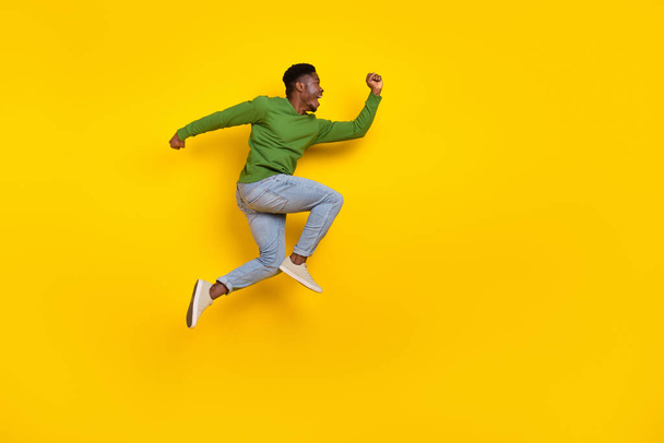 Full length body size view of attractive cheerful crazy guy jumping running isolated over bright yellow color background. - Valokuva, kuva