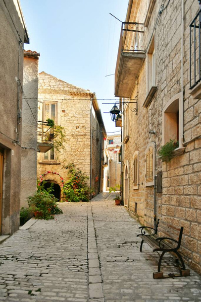 A narrow street between the old stone houses of Oratino, a medieval village in the Molise region of Italy. - Zdjęcie, obraz
