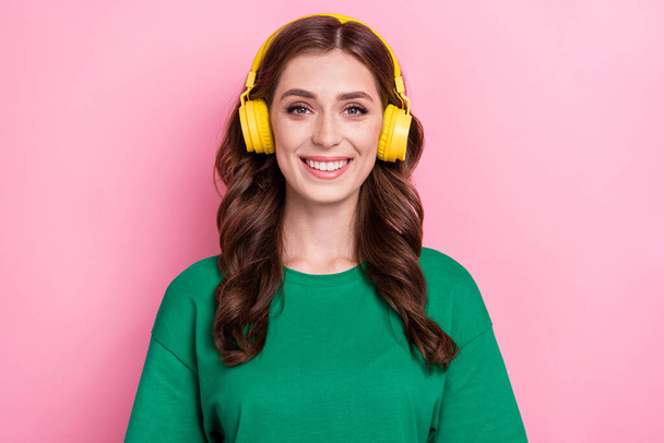 Photo of pleasant nice woman with wavy hairdo dressed green t-shirt headphones listen favorite track isolated on pink color background. - Φωτογραφία, εικόνα