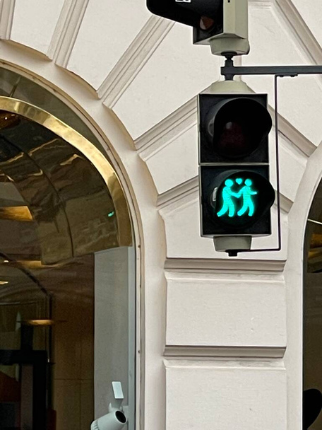 Adorable traffic lights with same sex couple walking, glowing green - Photo, Image