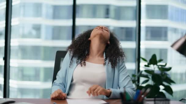 Unmotivated woman office worker tired of work sitting modern desk with papers close up. Upset exhausted girl touching head by hands feeling anxious. Latina businesswoman worried company problems. - Footage, Video