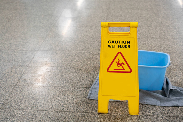 Warning sign caution wet floor indoor, close up - Φωτογραφία, εικόνα
