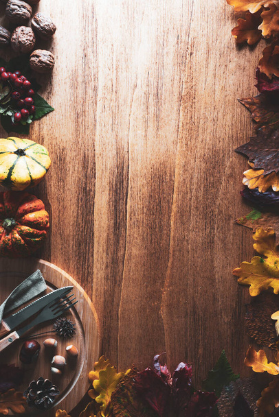 Thanksgiving day concept with pumpkins and autumn leaves, background, top view - Fotó, kép