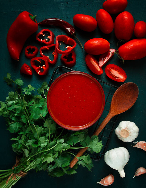 Tomato sauce, tomatoes and sweet pepper, Georgian Satsebeli sauce, with ingredients on a dark background, top view, close-up, no people, - Foto, afbeelding