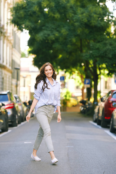 Fashion portrait of beautiful young woman, wearing blue shirt, posing outdoors - Photo, Image