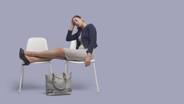 Young elegant businesswoman sitting on a chair and sleeping - Zdjęcie, obraz