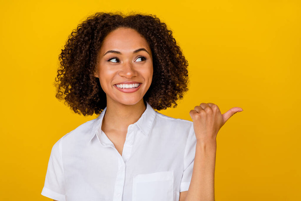 Close up photo of charming lady beaming smile look up index arm thumb empty space dentist whitening ad isolated on yellow color background. - Fotoğraf, Görsel