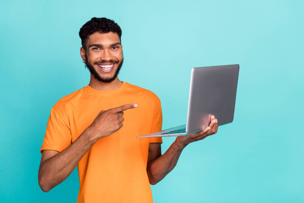 Photo of positive person toothy smile indicate finger wireless netbook isolated on aquamarine color background. - Valokuva, kuva