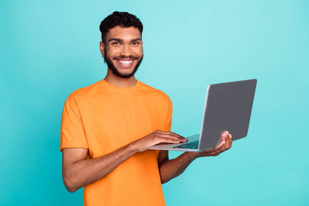 Photo of positive satisfied man hold use netbook write email toothy smile isolated on emerald color background. - Φωτογραφία, εικόνα