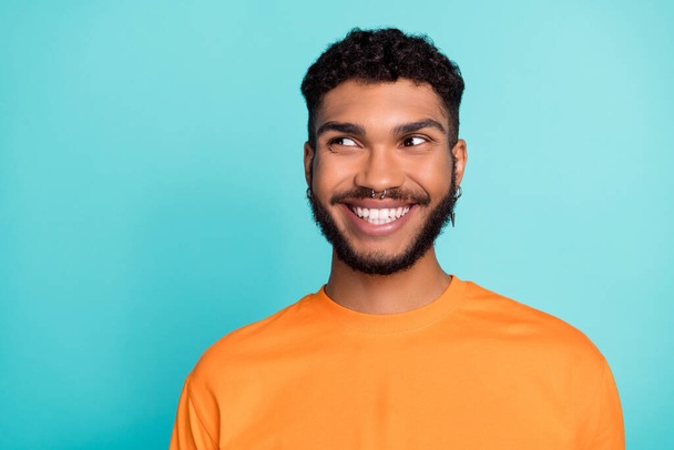 Close up photo of postive cheerful man interested look empty space shopping low price black friday isolated on cyan color background. - Foto, immagini