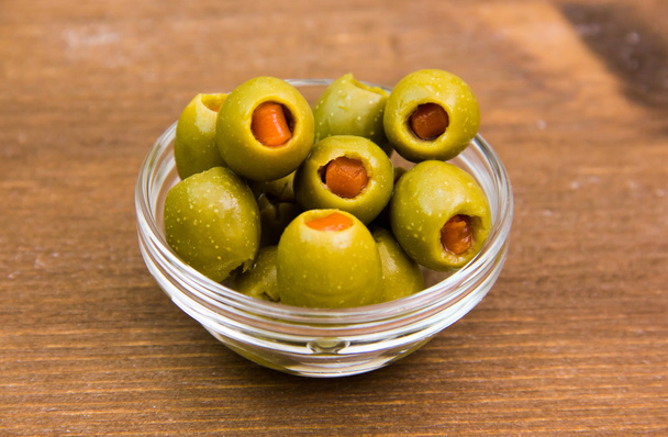 Stuffed olives on bowl on wood - Photo, Image