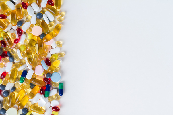 Many different colorful medication and pills from above on white background with copy space - 写真・画像