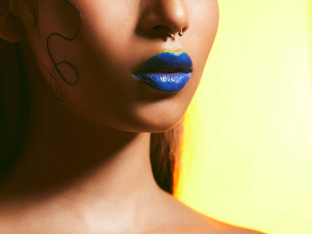 Its the mouth that proves just how bold we are. Studio shot of a beautiful young woman wearing blue lipstick - Foto, immagini