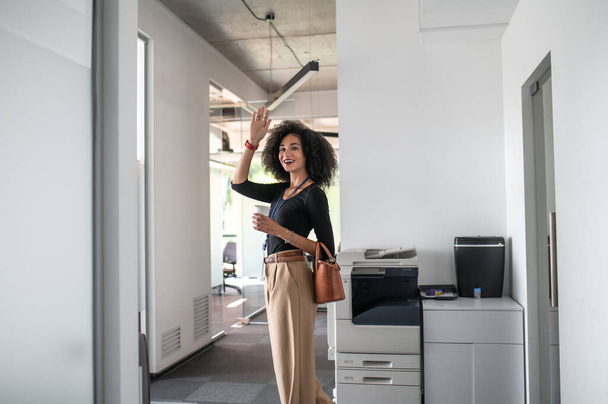 Morning in the office. Confident curly-haired business woman in the office - Photo, Image