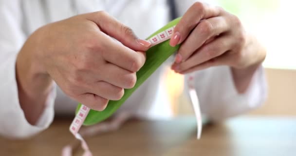 Green cucumber doctor measures with measuring tape indicates length of male penis. Male health and erection patent - Video, Çekim
