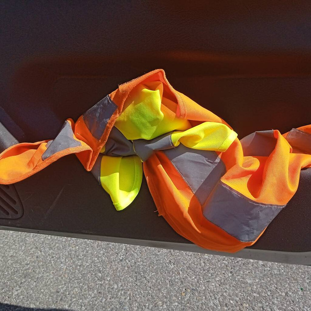 a warning vest or a safety vest in the car - Photo, Image