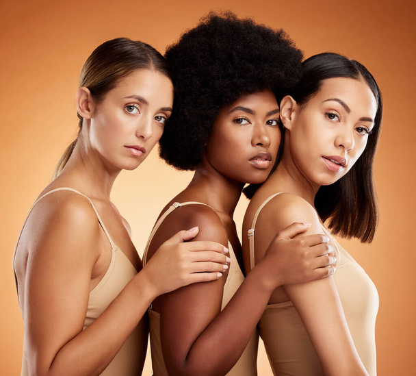 Diversity, women and natural beauty skincare and wellness cosmetics. Proud, confident and healthy girls portrait together, morning facial and body care routine in studio with brown background - Foto, imagen