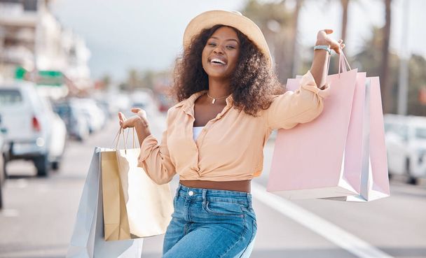 Fashion black woman with shopping bags in city or happy with sale, discount or luxury retail brands of clothes. Customer with smile, boutique products or designer gift form store or shopping mall. - Фото, зображення