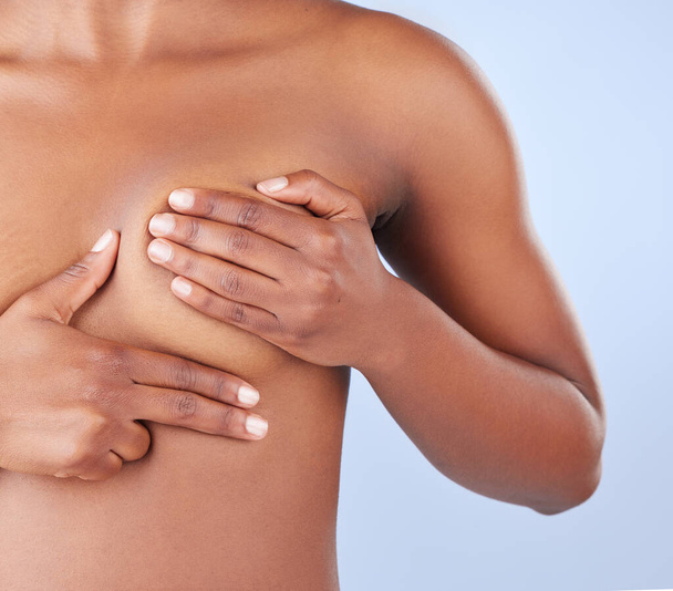 Regular breast exams can help you maintain breast health. Studio shot of an unrecognisable woman examining her breast - Photo, Image