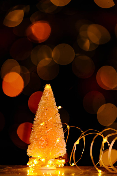 Christmas tree background with shining bokeh.Christmas tree Festive bokeh background.Christmas and New Year background.Winter holidays wallpaper - Foto, afbeelding
