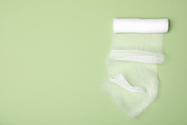 White medical bandage on light green background, top view. Space for text - Foto, Imagem