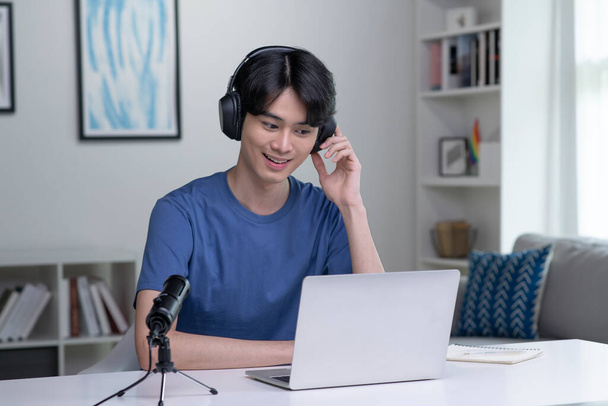 İş yerinde mutlu ve pozitif hissediyorum. Genç Asyalı iş adamı bilgisayarında müşterilerle video görüşmesinde kulaklık takıyor. Genç Asyalı adam online eğitim sınıfı konferansı veriyor, danışmanlık yapıyor.. - Fotoğraf, Görsel