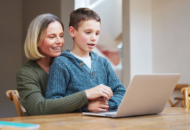 Youve been doing so well. a mother helping her son complete his homework using a laptop - Photo, Image